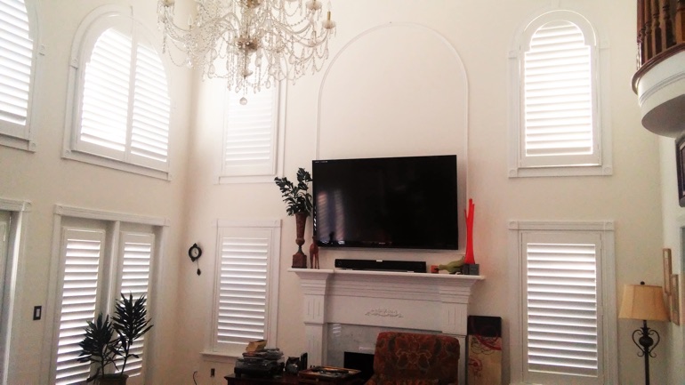 San Diego great room with wall-mounted television and arc windows.